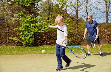 Far og søn spiller tennis