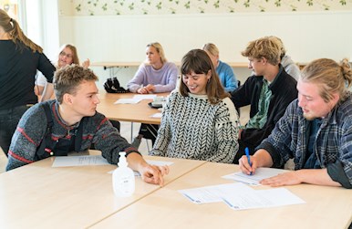 Unge arbejder ved bord